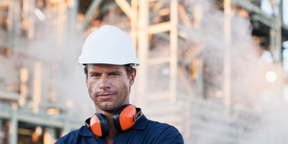 Worker with steam in the background